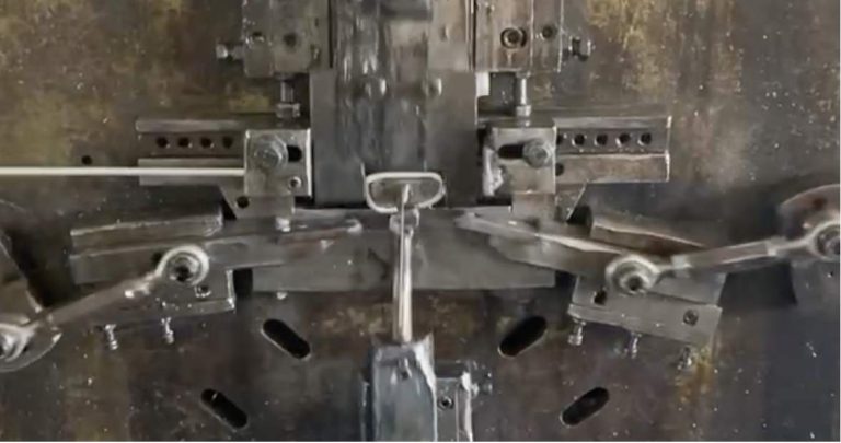 alt="Automatic bending machine forming during the first step of production">
