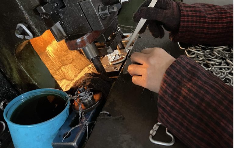 alt="Step 3: punching on both sides using a precision press machine"
