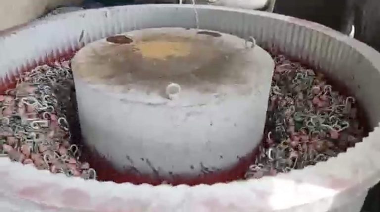 alt="Step 4: vibratory polishing process to smooth the aluminum  carabiner surface"
