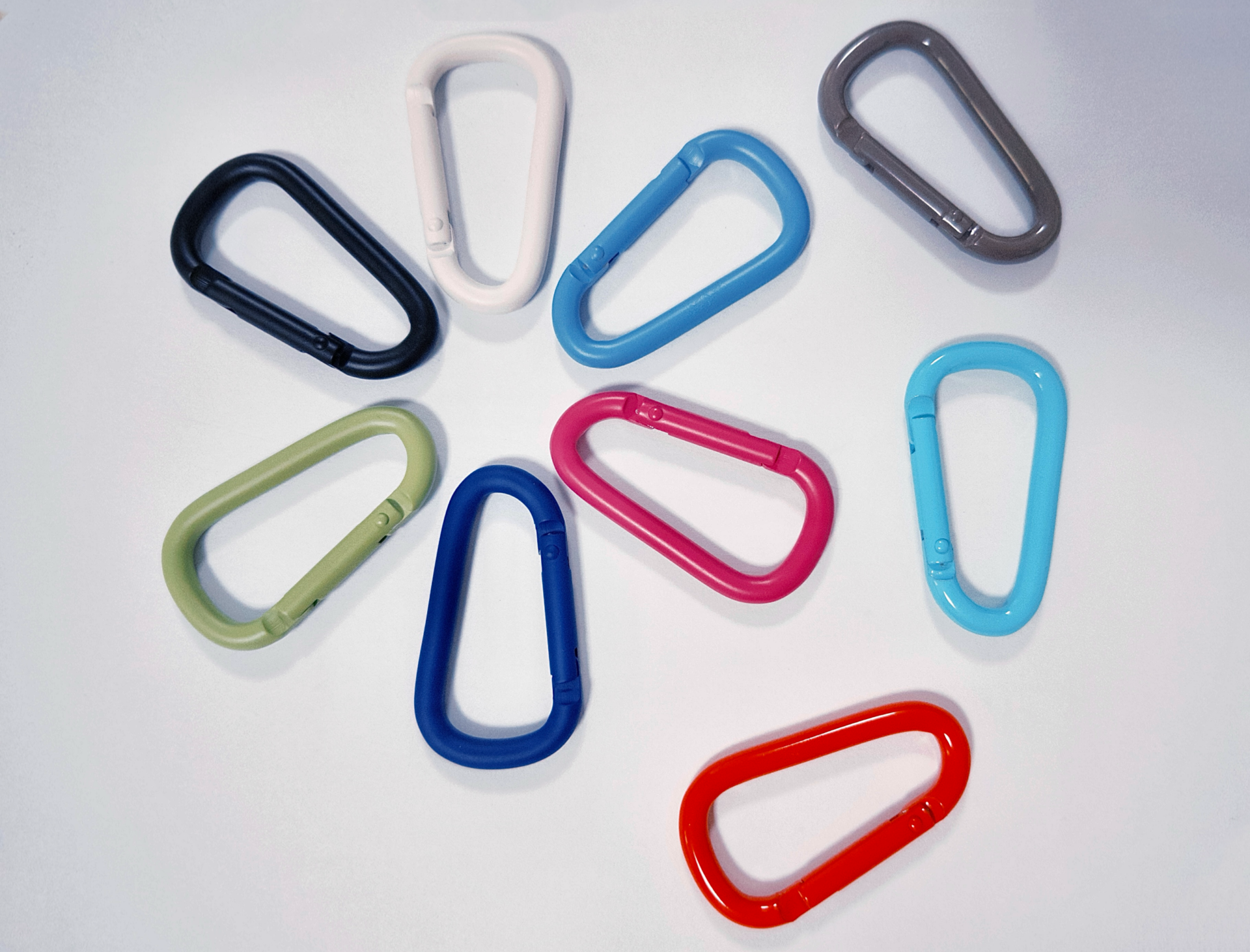Colorful spray-painted aluminum carabiners for everyday use and brand promotion.